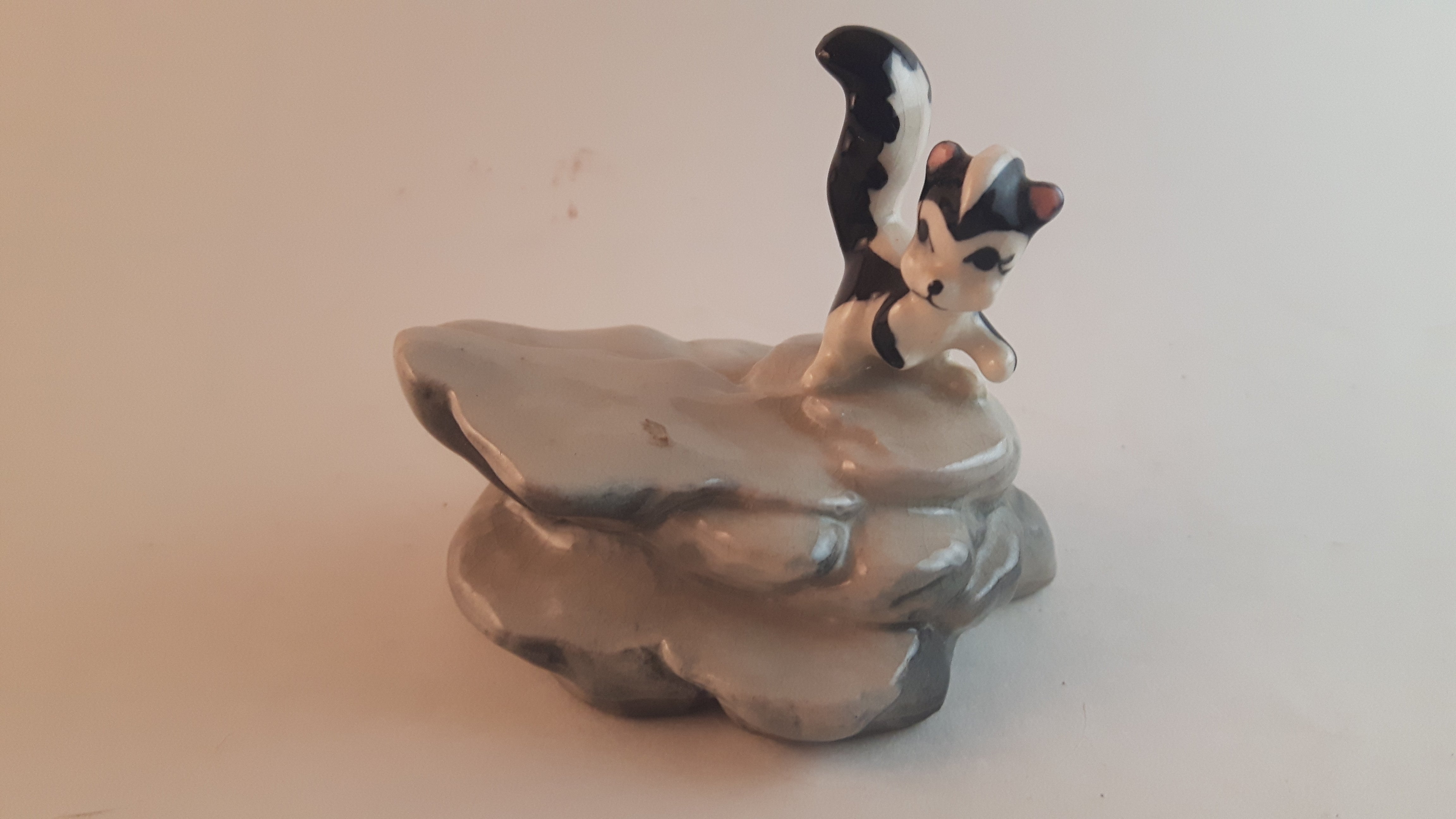Vintage Porcelain Skunk on a Rock Figurine