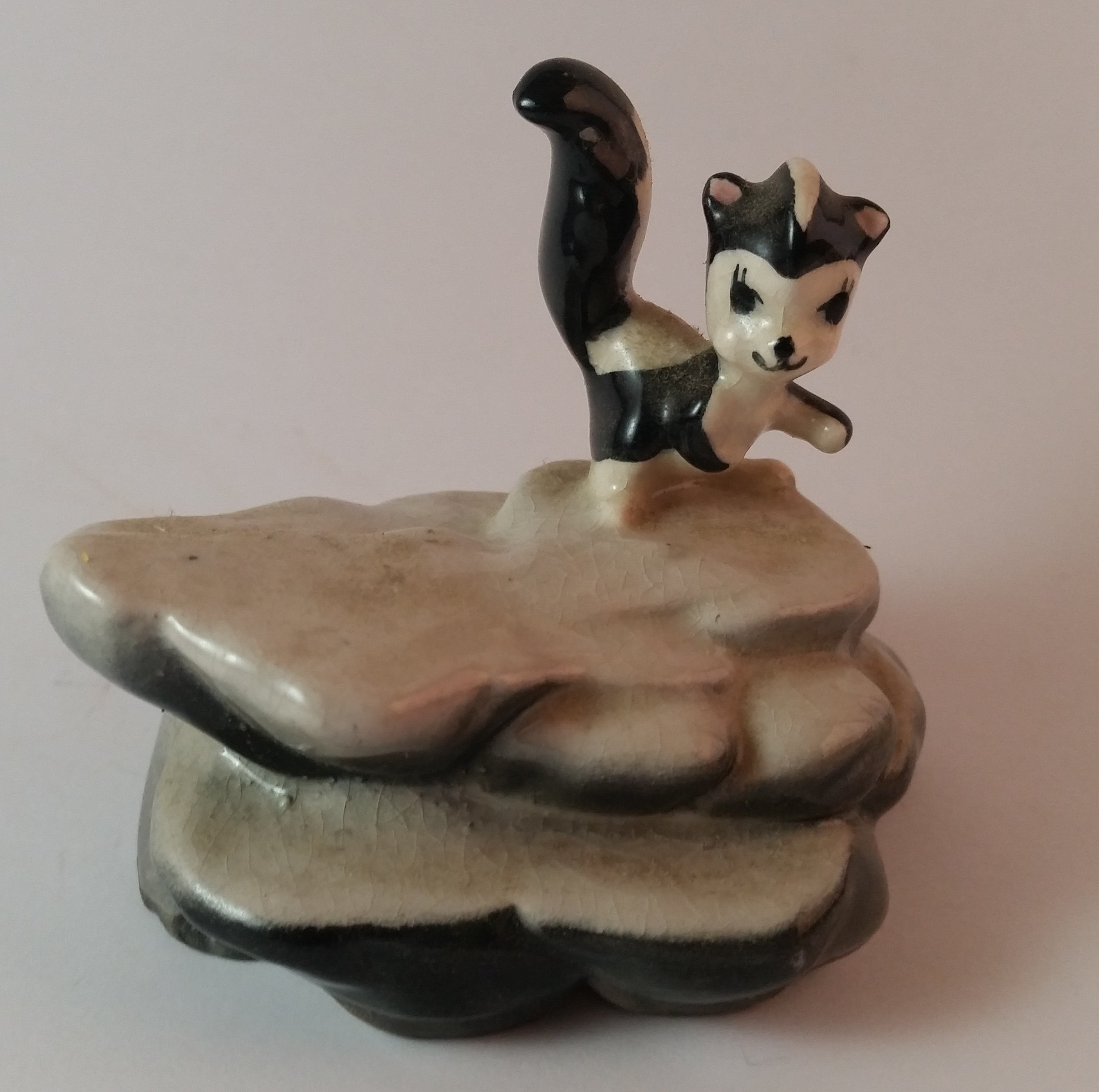 Vintage Porcelain Skunk on a Rock Figurine Has Crazing