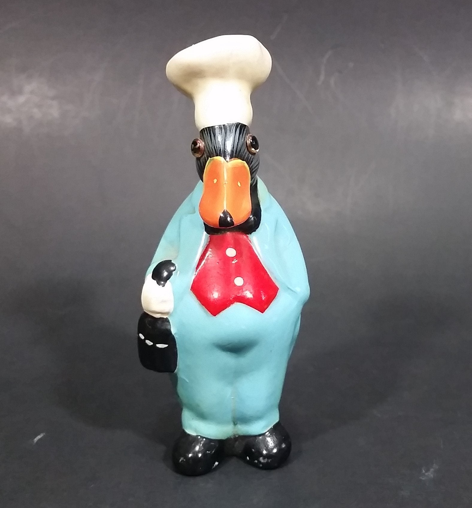 Vintage Black Duck in a Blue Suit Chef Cook Figurine Holding a Bottle of Bubbly