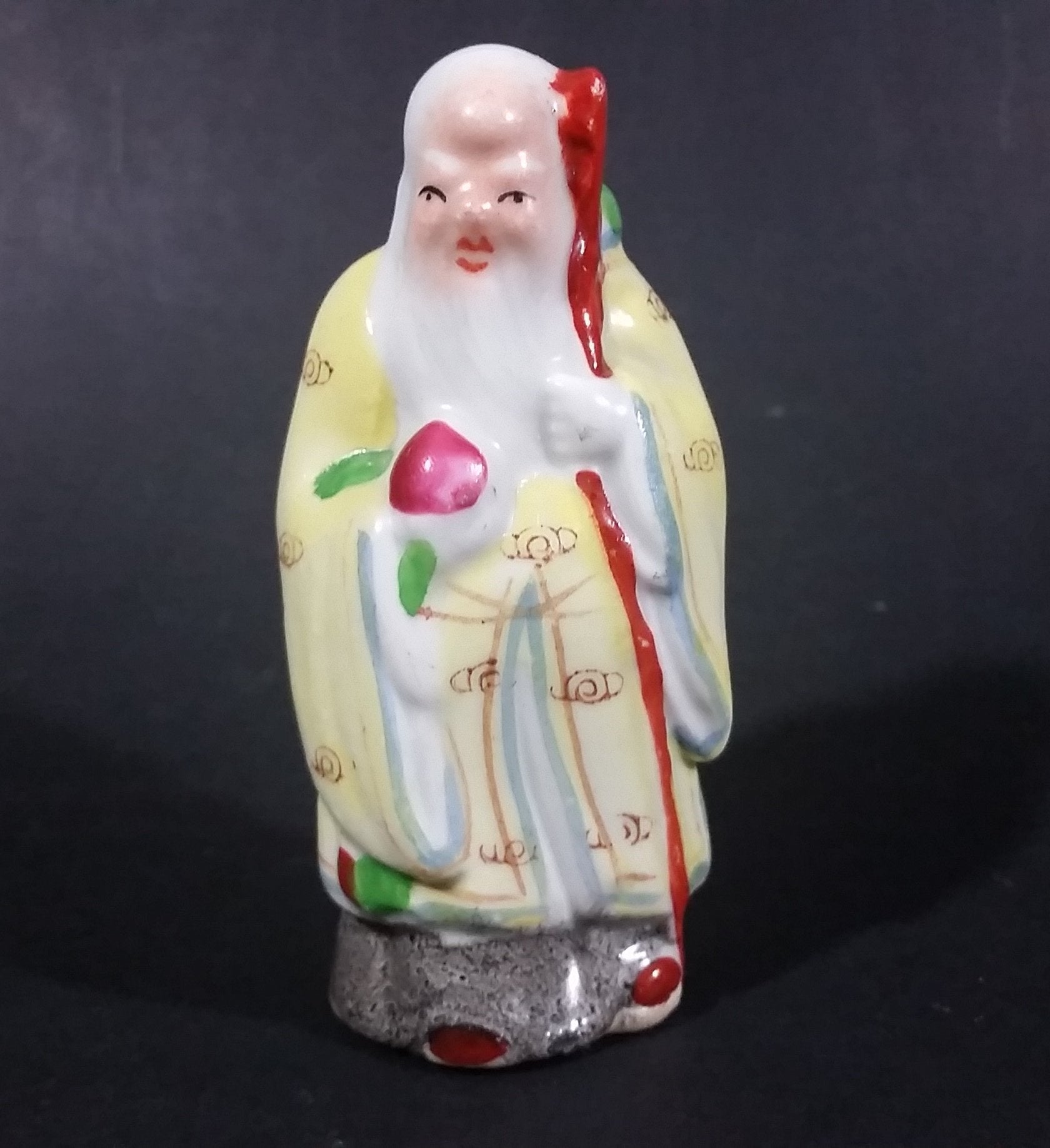 Vintage Chinese God Shou Wiseman in a Yellow Robe with Red Staff holding Fruit Ceramic Figurine