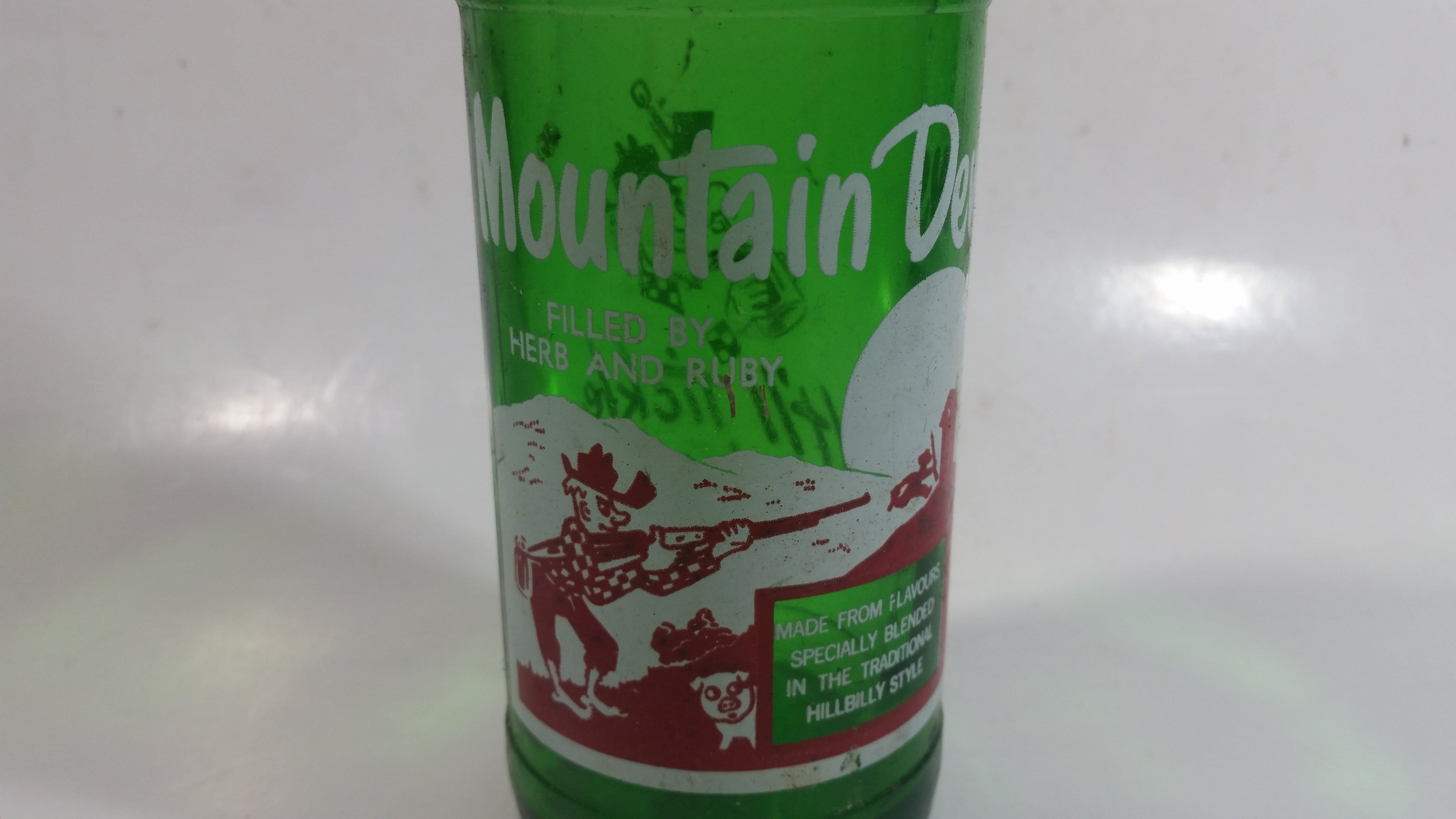 Vintage 1960s Mountain Dew Filled By Herb and Ruby "Hillbilly Style" Green Glass Soda Pop Beverage Bottle "It'll tickle your innards!" 2