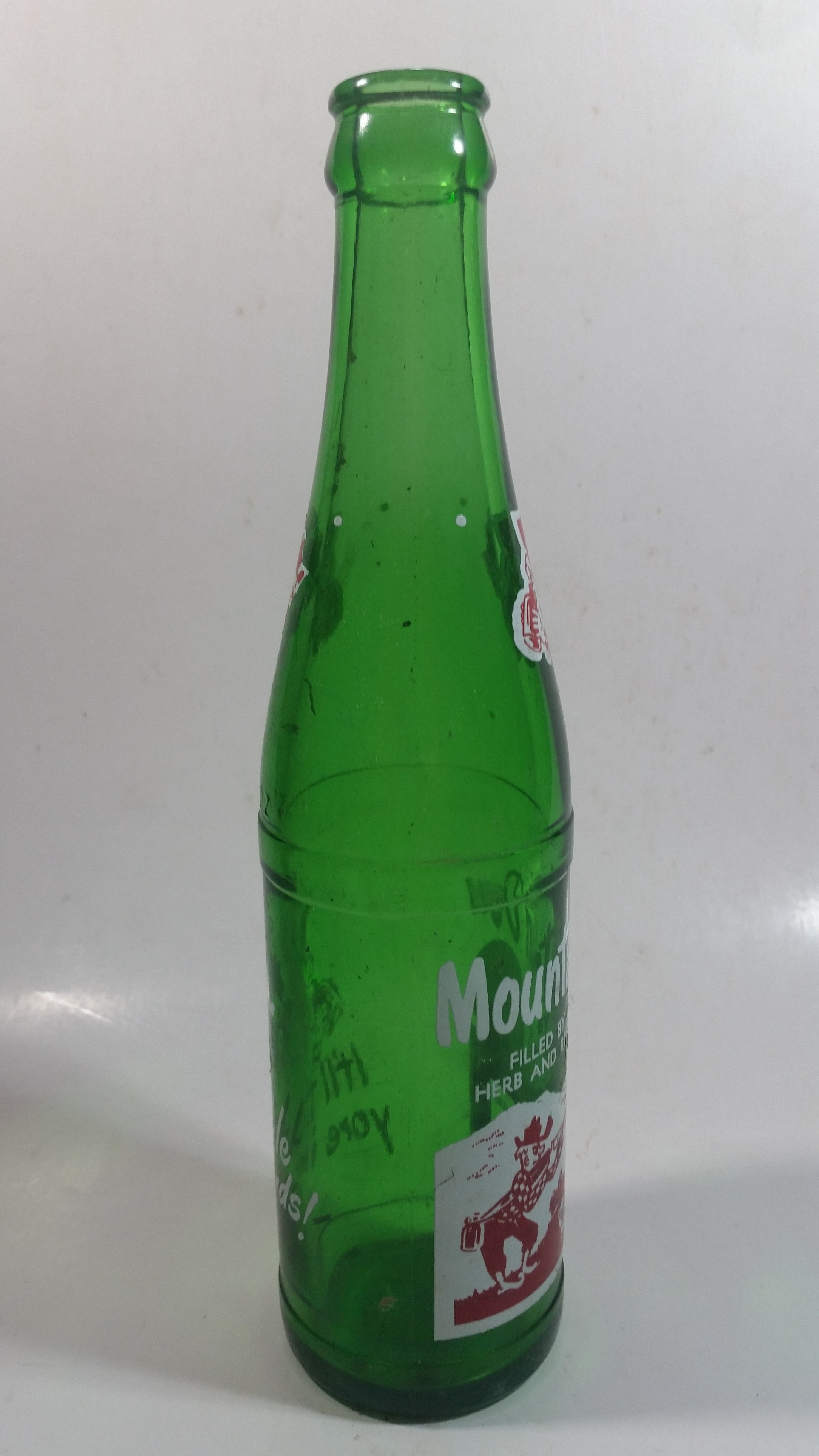 Vintage 1960s Mountain Dew Filled By Herb and Ruby "Hillbilly Style" Green Glass Soda Pop Beverage Bottle "It'll tickle your innards!" 6