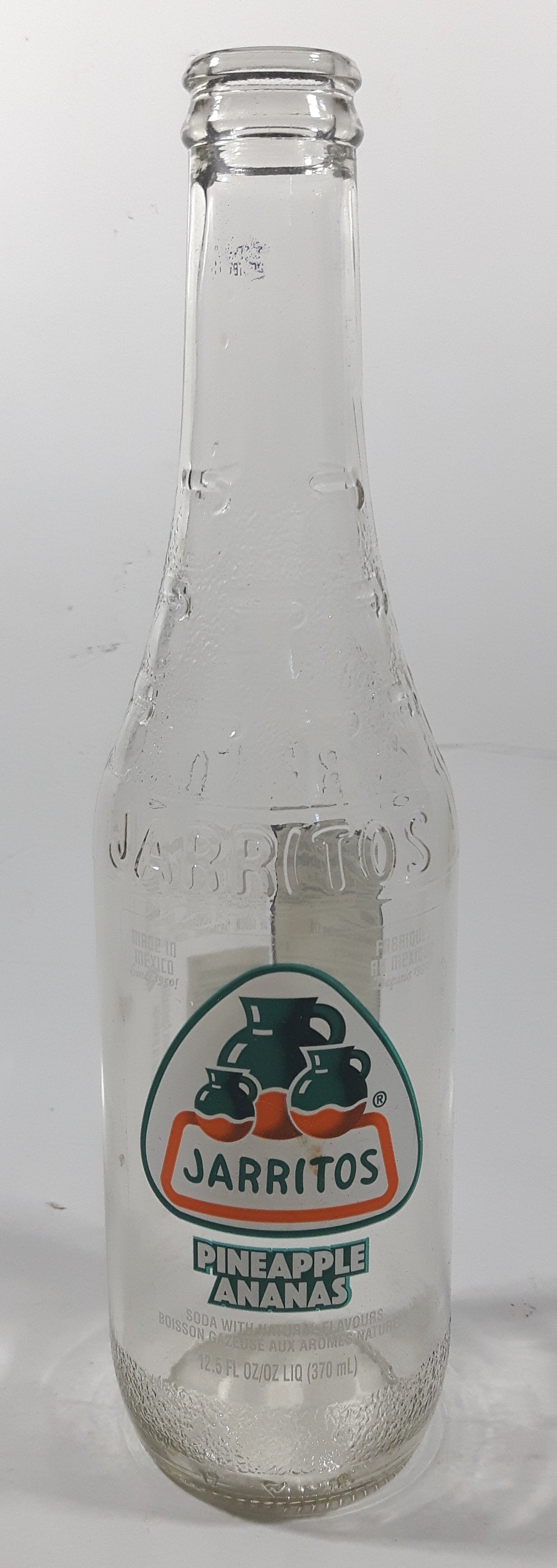 Jarritos Pineapple 9 1/4" Tall 370mL 12.5 Fl Oz. Embossed Clear Glass Soda Pop Bottle